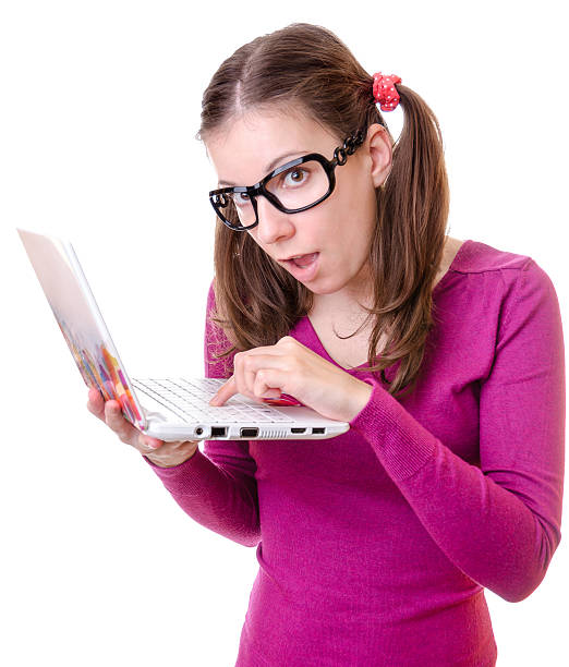Geeky woman with a laptop Geeky woman with a laptop isolated on white ugly skinny women stock pictures, royalty-free photos & images