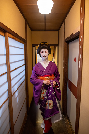 Japanese mid adult female friends visiting Kyoto and experiencing Geiko (Geisha) makeover. Wearing gorgeous kimono for Geisha with 'Oshiroi' special white face makeup.