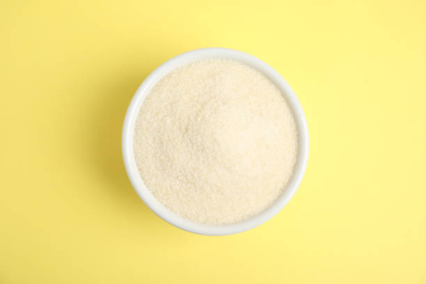 Gelatin powder in bowl on yellow background, top view Gelatin powder in bowl on yellow background, top view texturizer stock pictures, royalty-free photos & images