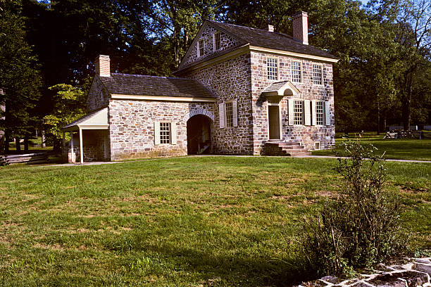 General Washington's Headquarters In December of 1777 General George Washington located his headquarters at this small house in the village of Valley Forge, Pennsylvania, USA. The General and up to 25 of his staff worked and lived in the house. Mrs. Washington also joined him there for several months of the winter. Washington's troops however were not afforded the same luxury. They endured the cold snowy winter crowded into tiny log cabins. jeff goulden historic stock pictures, royalty-free photos & images