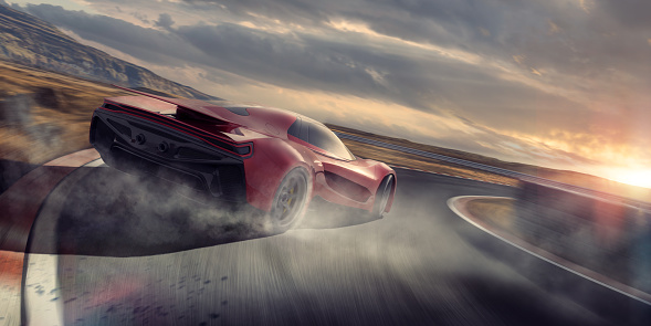 A generic red sports car moving at high speed around the corner of a racetrack. The vehicle is drifting around the corner, with smoke coming from its spinning rear tires. The racetrack is fictional in a remote location near to hill. It is sunset under a cloudy evening sky.