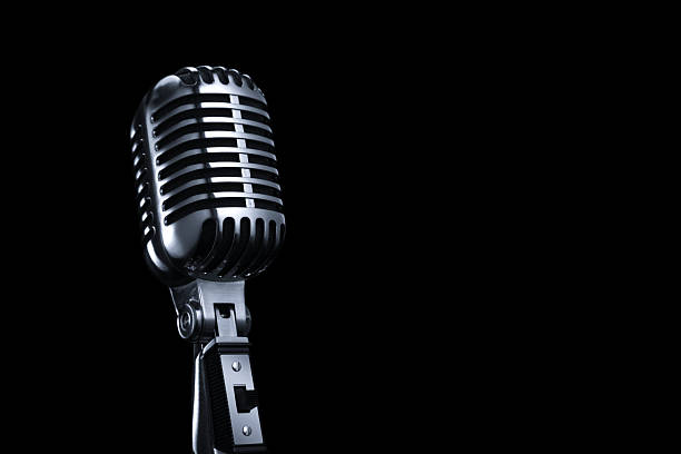 Generic Vintage Microphone on a Black Background The microphone is isolated on a black background. Focus falls off on the top a little bit.click on the links below to view lightboxes. microphone stock pictures, royalty-free photos & images