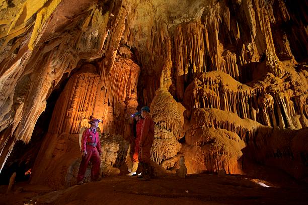 geologist in cave - stalagmiet stockfoto's en -beelden