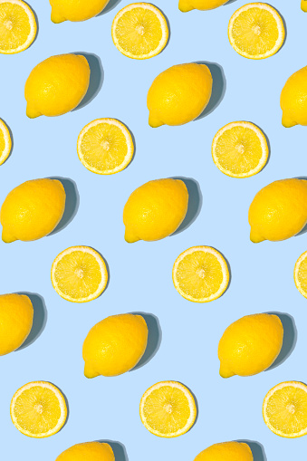 Composition with whole and sliced lemons, cut out. Top view.