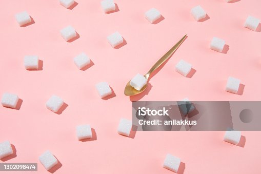 istock Geometry Pattern Made of White Sugar Cubes on Pink Background 1302098474