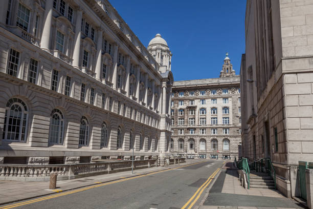 Georges Dock Way in Liverpool Liverpool, England - June 20, 2010: Georges Dock Way on Mann Island, with the Port of Liverpool building on the left and the Cunard and Liver Buildings in the background, in Liverpool, England cunard building liverpool stock pictures, royalty-free photos & images