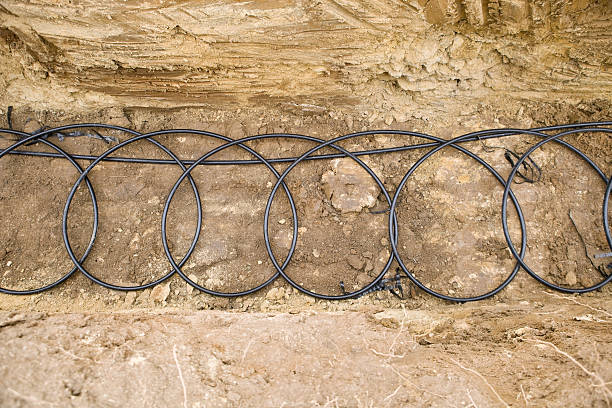 geothermal pipe coils at the bottom of a trench - warmtepomp stockfoto's en -beelden