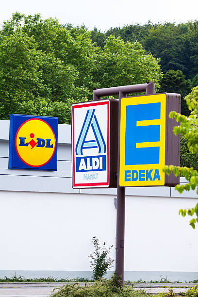 German discounters Essen, Germany - June 21, 2014: Capture of three German discounter supermarkets and logos seen from shared area of parking space, There are three discounters Lidl, Aldi North and Edeka. Seen in Essen Kettwig. lidl stock pictures, royalty-free photos & images
