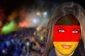 Beautiful German girl with the flag painted on her face