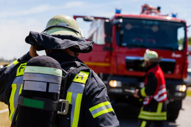 german fireman ( Feuerwehr ) stands near an accident stock photo