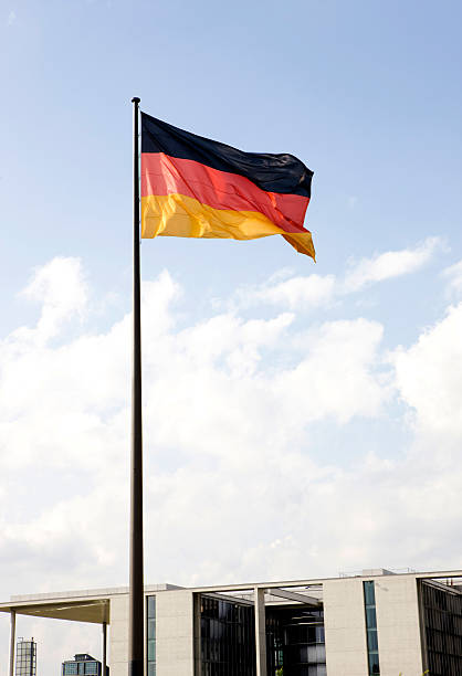 German flag against blue sky. stock photo