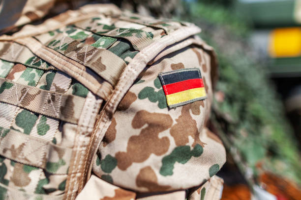 german flag on a german soldier desert uniform stock photo
