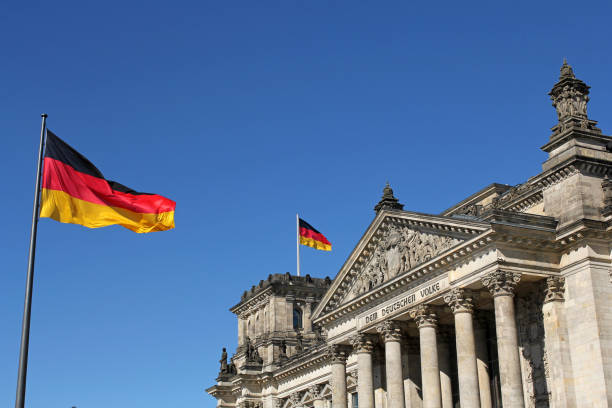 German flags and Reichstag building in Berlin, Germany stock photo