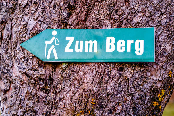 german hiking sign translation: "to the hill" stock photo