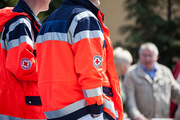 german paramedics in red Jackets on a street stock photo