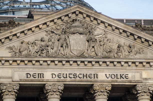 German parliament building (Reichstag) in Berlin, detail on the entrance. German parliament building (Reichstag) in Berlin, Germany with writings that mean "The German People". german social democratic party stock pictures, royalty-free photos & images