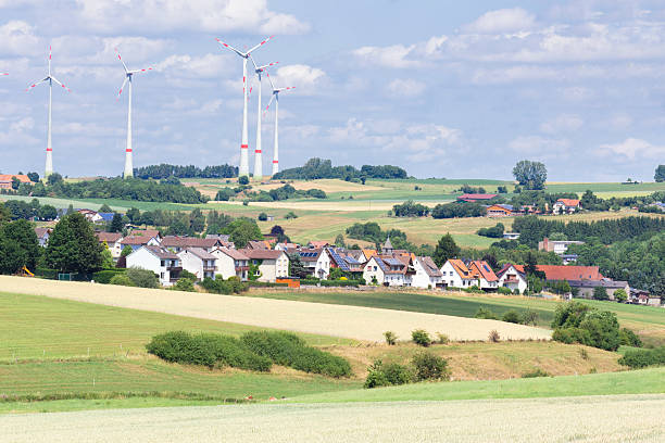 German village with houses, windmills and corn fields stock photo
