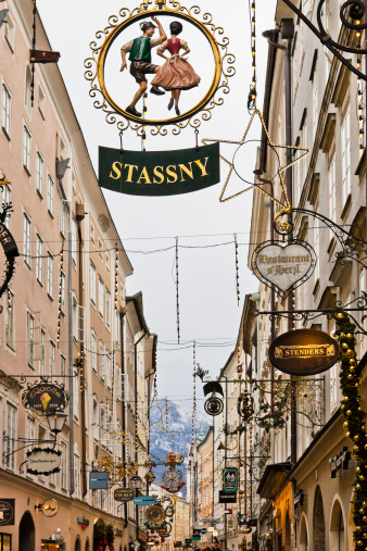 Salzburg, Austria - December 9, 2010: Wrought iron sign along the Getreidegasse. This is one of the most charming streets of Salzburg, lined with old buildings which house shops and restaurants, all characterized by beautiful wrought iron signs.
