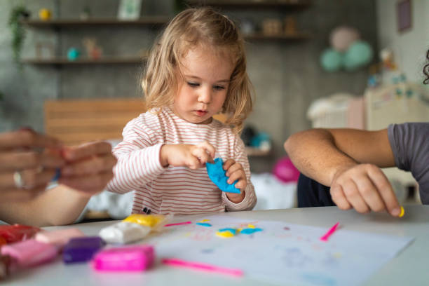 Getting creative with plasticine modeling clay Cute toddler girl making shapes of plasticine modeling clay, unrecognizable people next to her 2 3 years stock pictures, royalty-free photos & images