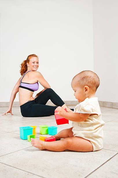 Getting fit with the baby A mother keeping fit after her pregnancy.To view a broader range of childhood and family images please click here: post partum exercises stock pictures, royalty-free photos & images