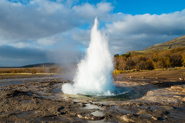 Geyser eruption The beginning of an eruption in Strokkur geyser in Iceland, geothermal energy stock pictures, royalty-free photos & images