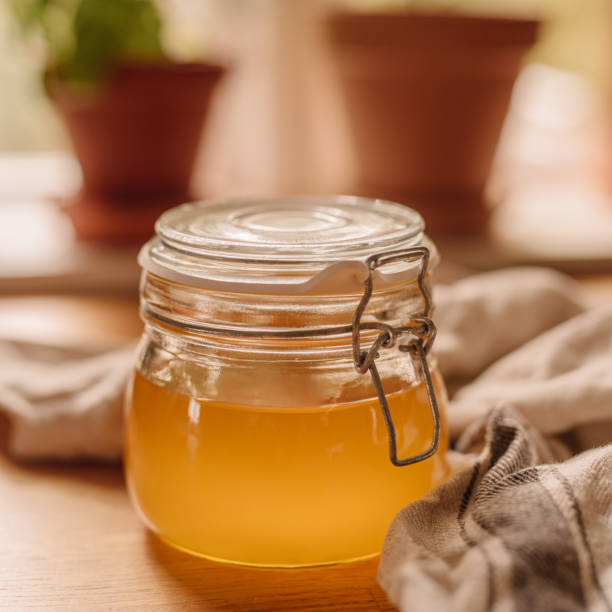 Ghee clarified butter in jar Ghee clarified butter in jar
photo taken indoors in kitchen of full newly homemade ghee ghee stock pictures, royalty-free photos & images