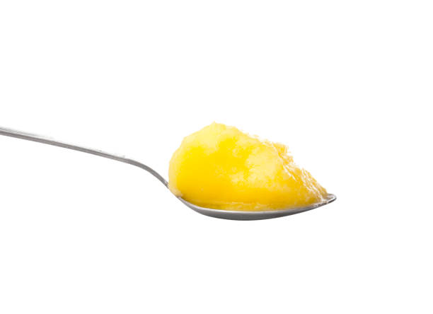 Ghee Spoon Spoon Full of Ghee on White ghee stock pictures, royalty-free photos & images