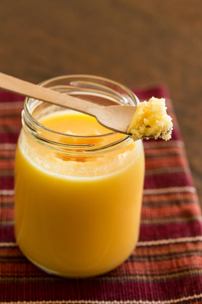 Ghee/clarified butter Homemade Ghee/clarified butter in a glass jar ghee stock pictures, royalty-free photos & images