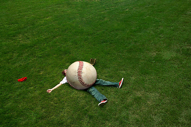 giant baseball A giant baseball lands on a player. oversized object stock pictures, royalty-free photos & images