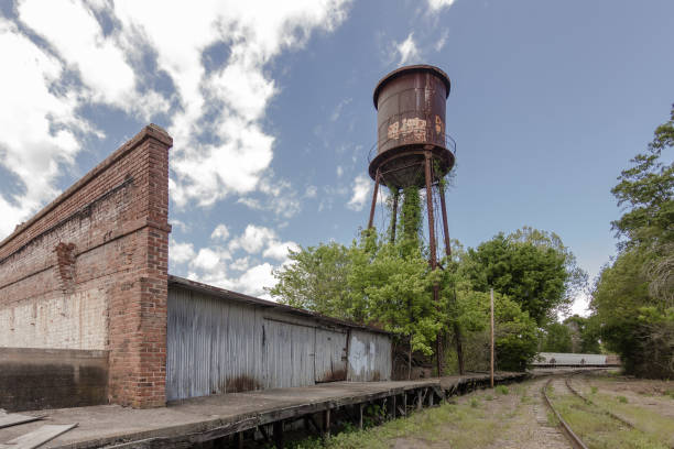 Giant water tower looms of abandoned factory stock photo