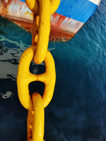 Giant yellow chain detail closeup from battleship anchor