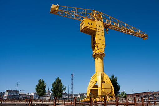 Giant yellow crane towering over landscape