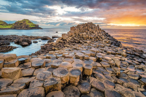 Giant's Causeway Sunset Northern Ireland UK Stock photograph of a dramatic sunset at the Giant's Causeway in Northern Ireland, UK. basalt column stock pictures, royalty-free photos & images