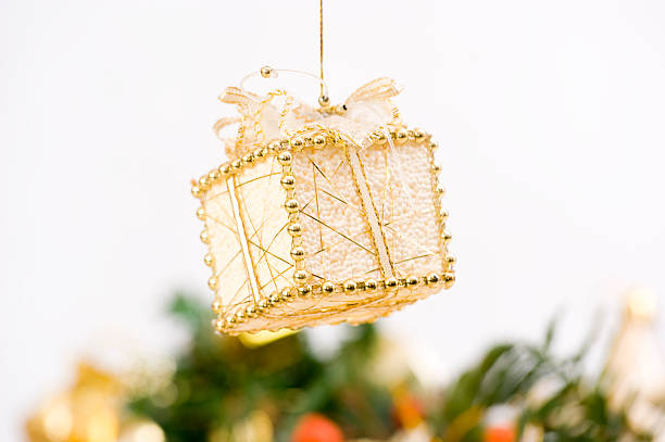 Gift Bauble in Front of Christmas Decoration stock photo