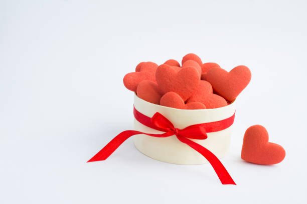 Gift box with red hearts shaped cookies on the white background. Close-up. Copy space. stock photo