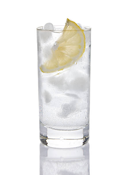 Gin or Vodka Tonic A Gin or Vodka Tonic with lots of ice isolated on white in high key. highball glass stock pictures, royalty-free photos & images