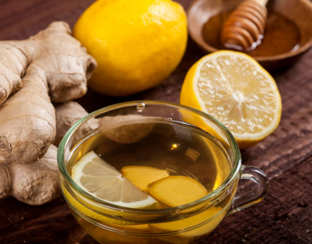 Ginger tea with lemon on wooden background stock photo