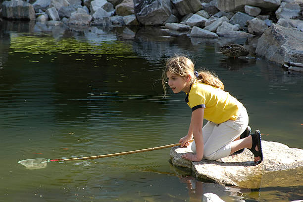 girl at pond stock photo