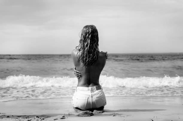 Black nude girl beach 20 Pretty Woman Nude Sitting From The Back On Beach Stock Photos Pictures Royalty Free Images Istock