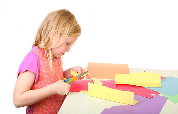 girl cutting paper stock photo