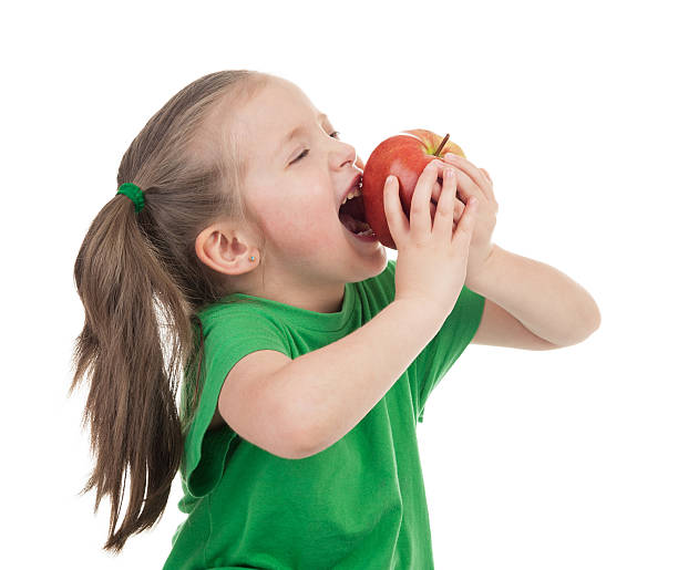 girl eat apple on white stock photo