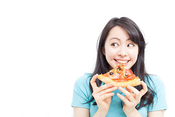 Girl eating pizza stock photo