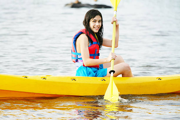 Girl in kayak on lake stock photo