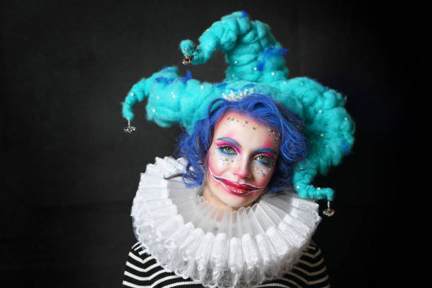 girl in makeup and costume jester . stock photo