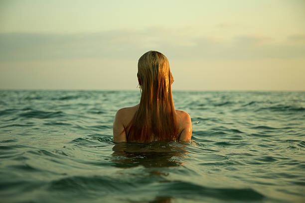 girl in sea waves stock photo