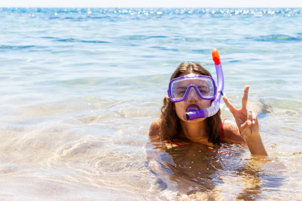girl is engaged in scuba diving in a clean clear sea. young girl dressed in glasses and a tube for swimming girl is engaged in scuba diving in a clean clear sea. young girl dressed in glasses and a tube for swimming. hot egyptian women stock pictures, royalty-free photos & images