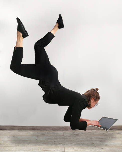 girl levitating in front of the computer - business man shoes on desk imagens e fotografias de stock