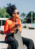 istock Girl listening to music at skatepark 1320529991
