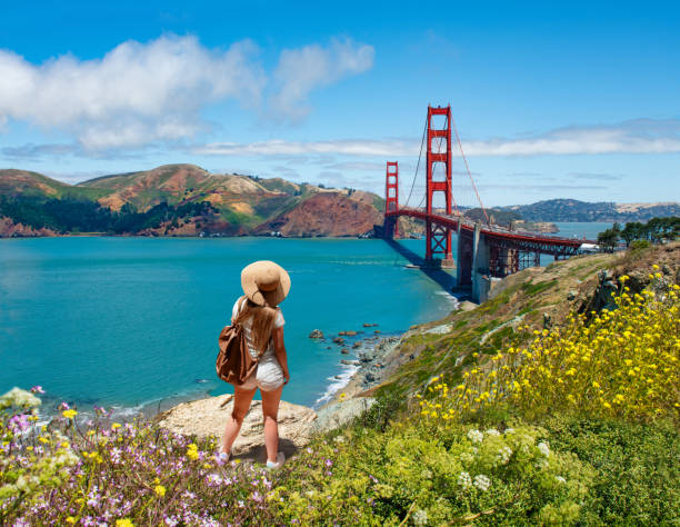 Girl looking at beautiful summer coastal landscape, on hiking trip. stock photo