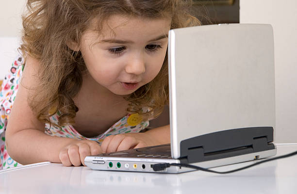 Girl looking DVD player Little girl looking with amazement to a DVD player Portable DVD Player stock pictures, royalty-free photos & images